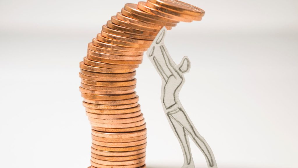 a paper doll of a man holding a stack of coins