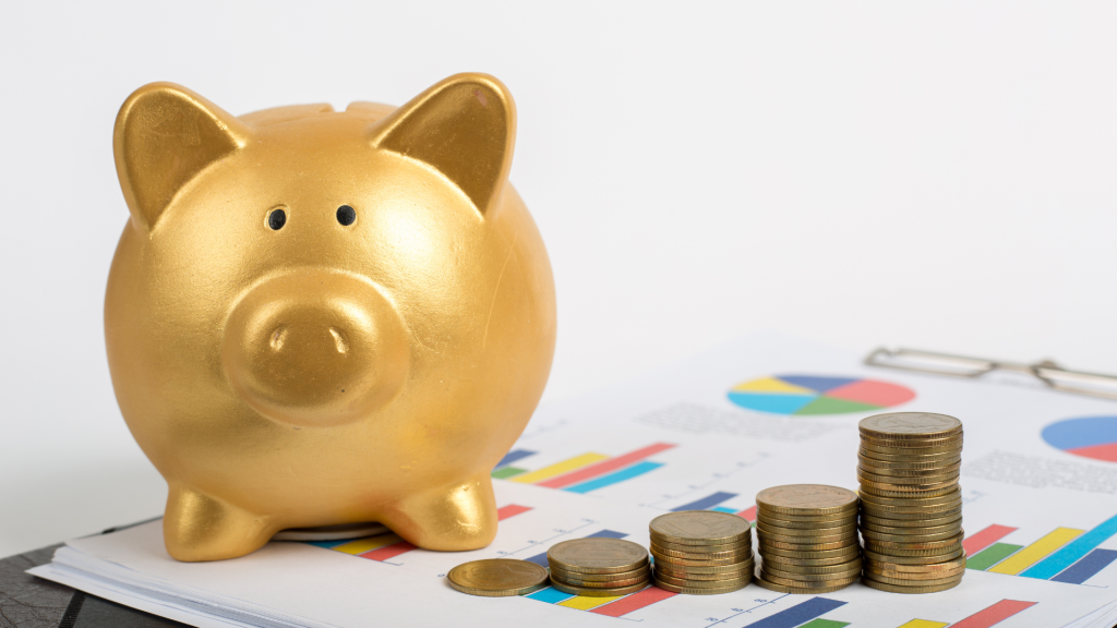 Golden piggy bank with stacked coins on financial charts representing strategic alternative financing options.