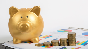 Golden piggy bank with stacked coins on financial charts representing strategic alternative financing options.