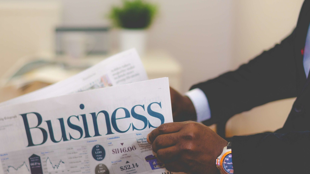 Businessman reading financial news about small business lending myths and market trends