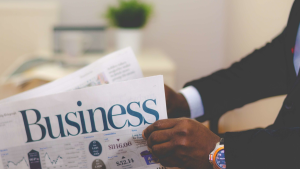 Businessman reading financial news about small business lending myths and market trends