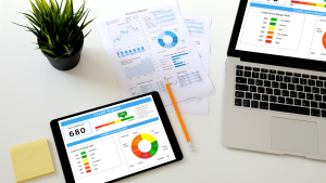 Tablet and laptop displaying business credit reports and analytics for small business financing review.