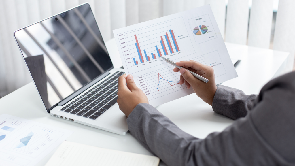 Business owner evaluating charts and ROI from 0% interest commercial loan programs and financing data
