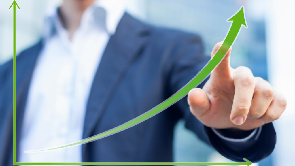 Businessman pointing at an upward growth chart representing smart financing strategies.