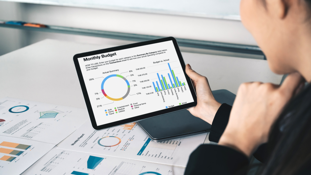 Businesswoman reviewing a monthly budget dashboard to evaluate debt impact and growth opportunities.
