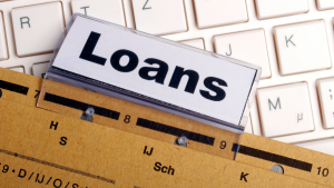 Loans folder over computer keyboard symbolizing alternative financing tools for entrepreneurs